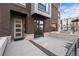 Modern townhome exterior with brick facade, private front patio, and street view at 4062 W 16Th Ave, Denver, CO 80204