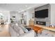 Open concept living area with fireplace, modern sofa, and view of the kitchen and dining area at 4062 W 16Th Ave, Denver, CO 80204