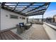 Expansive rooftop patio features a pergola, outdoor seating, and durable wood flooring at 4062 W 16Th Ave, Denver, CO 80204