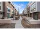 Exterior view of modern townhomes with landscaped walkways and shared outdoor spaces at 4062 W 16Th Ave, Denver, CO 80204