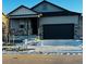 Gray two-story house with a black garage door and landscaping at 4680 Thistle Dr, Brighton, CO 80601