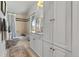 Bathroom with a shower and tub, white cabinets, a neutral rug, and a window at 5090 S Perry Park Rd, Sedalia, CO 80135