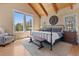 Bedroom featuring a large window, wood floors, and ample natural light at 5090 S Perry Park Rd, Sedalia, CO 80135