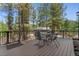 Deck overlooking the trees, featuring a metal table and chairs set for outdoor dining at 5090 S Perry Park Rd, Sedalia, CO 80135