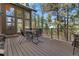 Wooden deck featuring a table and chairs, beautiful views of the surrounding trees and forest at 5090 S Perry Park Rd, Sedalia, CO 80135