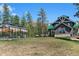 Beautiful exterior view featuring greenhouse, spacious lawn and a view of the mountains at 5090 S Perry Park Rd, Sedalia, CO 80135