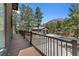 View of the garage, deck and exterior property with the home surrounded by trees at 5090 S Perry Park Rd, Sedalia, CO 80135