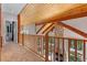 Hallway with wooden trim, stone fireplace extending upwards, wood plank ceilings and natural light at 5090 S Perry Park Rd, Sedalia, CO 80135