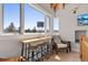 Bright hallway with table and chairs looking through multiple windows with a view of nature at 5090 S Perry Park Rd, Sedalia, CO 80135