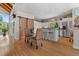 Open kitchen and dining area with island, bar stools, and sliding barn door at 5090 S Perry Park Rd, Sedalia, CO 80135