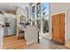 Bright kitchen and office nook with stainless steel refrigerator, desk area, and backyard views at 5090 S Perry Park Rd, Sedalia, CO 80135