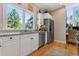 Kitchen area with stainless steel appliances, granite counters, and wood floors at 5090 S Perry Park Rd, Sedalia, CO 80135