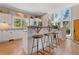 Bright kitchen with white cabinets, granite countertops, and counter seating at 5090 S Perry Park Rd, Sedalia, CO 80135