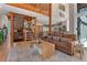 Living room with wood floors, leather sofa, and access to staircase and other areas of the home at 5090 S Perry Park Rd, Sedalia, CO 80135