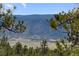 Picturesque mountain view framed by lush trees and foliage at 5090 S Perry Park Rd, Sedalia, CO 80135