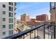 Apartment complex view from balcony showcases nearby brick buildings and urban street with parked cars at 2 Adams St # 608, Denver, CO 80206