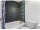 Modern bathroom with tiled shower and tub featuring blue accents, with white fixtures and clean design at 2 Adams St # 608, Denver, CO 80206