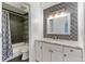 Updated bathroom features modern vanity, decorative mirror and shower/tub combo with elegant tiled backsplash at 2 Adams St # 608, Denver, CO 80206