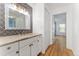 Bright bathroom featuring gray patterned accent wall, modern vanity, and white painted trim at 2 Adams St # 608, Denver, CO 80206