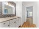 Updated bathroom with marble vanity and decorative wall, with an adjacent hallway leading to a bedroom at 2 Adams St # 608, Denver, CO 80206
