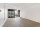 Bright bedroom featuring gray wood floors and expansive window with city views at 2 Adams St # 608, Denver, CO 80206