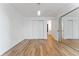 Bright bedroom with hardwood floors, double closets, and doorway leading to the bathroom and hallway at 2 Adams St # 608, Denver, CO 80206