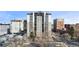 High-rise apartment building with a parking lot and city views, set against a bright blue sky at 2 Adams St # 608, Denver, CO 80206