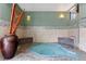 Cozy indoor hot tub with tile accents, mood lighting, and relaxing benches for residents at 2 Adams St # 608, Denver, CO 80206