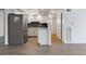 Modern kitchen featuring white cabinets, stainless steel appliances, and a dark mosaic backsplash at 2 Adams St # 608, Denver, CO 80206
