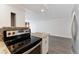 Modern kitchen featuring stainless steel appliances and granite countertops, adjacent to a living space with gray floors at 2 Adams St # 608, Denver, CO 80206