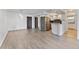 Open-concept living space with modern gray flooring, updated kitchen, and a sleek stainless steel refrigerator at 2 Adams St # 608, Denver, CO 80206