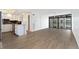 Open-concept living area with wood-look floors, bright natural light, and access to a balcony with large windows at 2 Adams St # 608, Denver, CO 80206