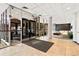 Lobby area with glass doors, a seating area, stone accent wall, and tile flooring at 2 Adams St # 608, Denver, CO 80206