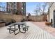 Enjoy outdoor dining with a built-in grill and ample seating on the landscaped patio at 2 Adams St # 608, Denver, CO 80206