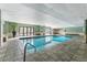 Bright and spacious indoor pool with clear water, tile surround, and relaxing seating areas at 2 Adams St # 608, Denver, CO 80206