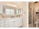 Clean bathroom with white vanity, quartz countertop and a shower/tub combo at 3242 S Heather Gardens Way, Aurora, CO 80014