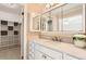 Bathroom with white vanity, quartz countertop and a walk-in shower at 3242 S Heather Gardens Way, Aurora, CO 80014