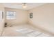 Simple carpeted bedroom with a ceiling fan and window at 3242 S Heather Gardens Way, Aurora, CO 80014