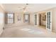 Spacious bedroom with double doors leading to en-suite bathroom and ceiling fan at 3242 S Heather Gardens Way, Aurora, CO 80014