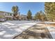 Townhouse community with snow-covered grounds and walkway at 3242 S Heather Gardens Way, Aurora, CO 80014