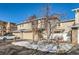 Two-story townhouse with attached garage and snowy landscaping at 3242 S Heather Gardens Way, Aurora, CO 80014