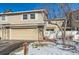 Tan siding townhouse with attached garage and small front yard at 3242 S Heather Gardens Way, Aurora, CO 80014