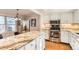 Updated kitchen featuring granite countertops and stainless steel appliances at 3242 S Heather Gardens Way, Aurora, CO 80014