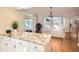 Kitchen with granite breakfast bar and white cabinetry at 3242 S Heather Gardens Way, Aurora, CO 80014