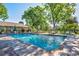 Community swimming pool with lounge chairs and trees at 3242 S Heather Gardens Way, Aurora, CO 80014