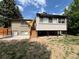 The backyard features a deck with stairs, yard and partial shade at 2043 S Salida St, Aurora, CO 80013