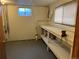 Basement room with workbench, window, and concrete flooring at 2043 S Salida St, Aurora, CO 80013
