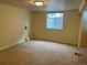 Basement room featuring carpeted floor, window, and neutral walls at 2043 S Salida St, Aurora, CO 80013