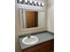 Bathroom vanity with a framed mirror, offering plenty of light and space at 2043 S Salida St, Aurora, CO 80013
