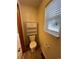 Small bathroom features a toilet, storage cabinet, and a bright window, offering practicality in a cozy space at 2043 S Salida St, Aurora, CO 80013